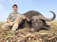 Young hunter with Cape buffalo bull trophy