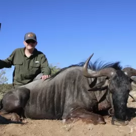 Hunter with trophy wildebeest