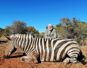 Hunter with trophy zebra