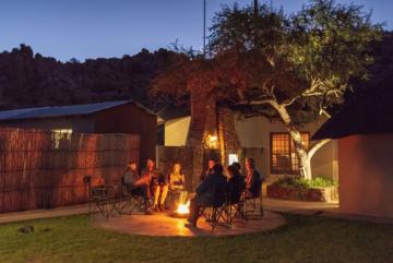 Family gathered around Namibia Lodge Fire Pit