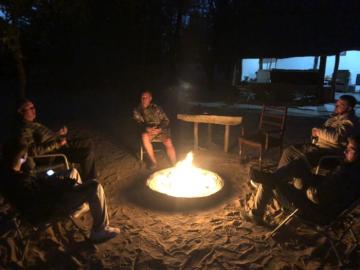 Leopard hunters around a fireplace in Zimbabwe